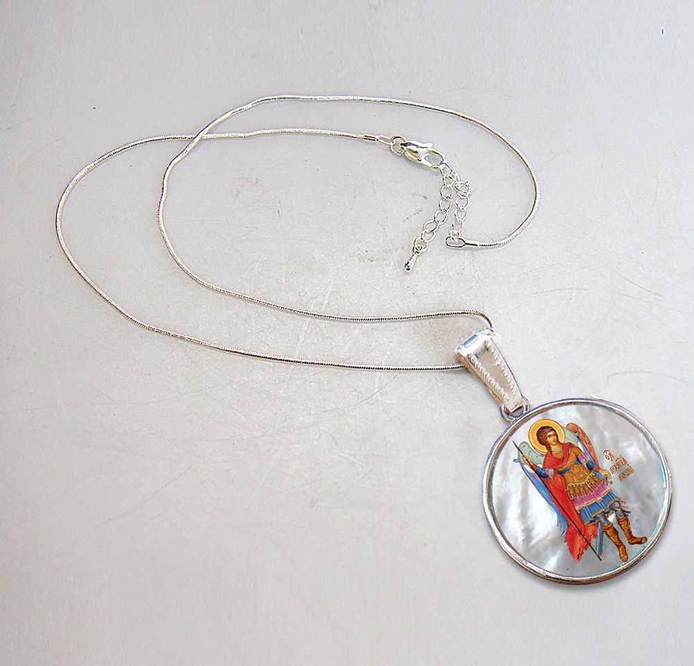 A beautifully handcrafted Saint Michael the Archangel necklace, with a hand-painted icon on a Mother-of-Pearl cabochon and a silver-plated chain.