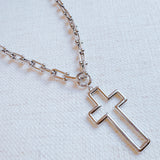 A silver cross pendant necklace on a U-shaped chain