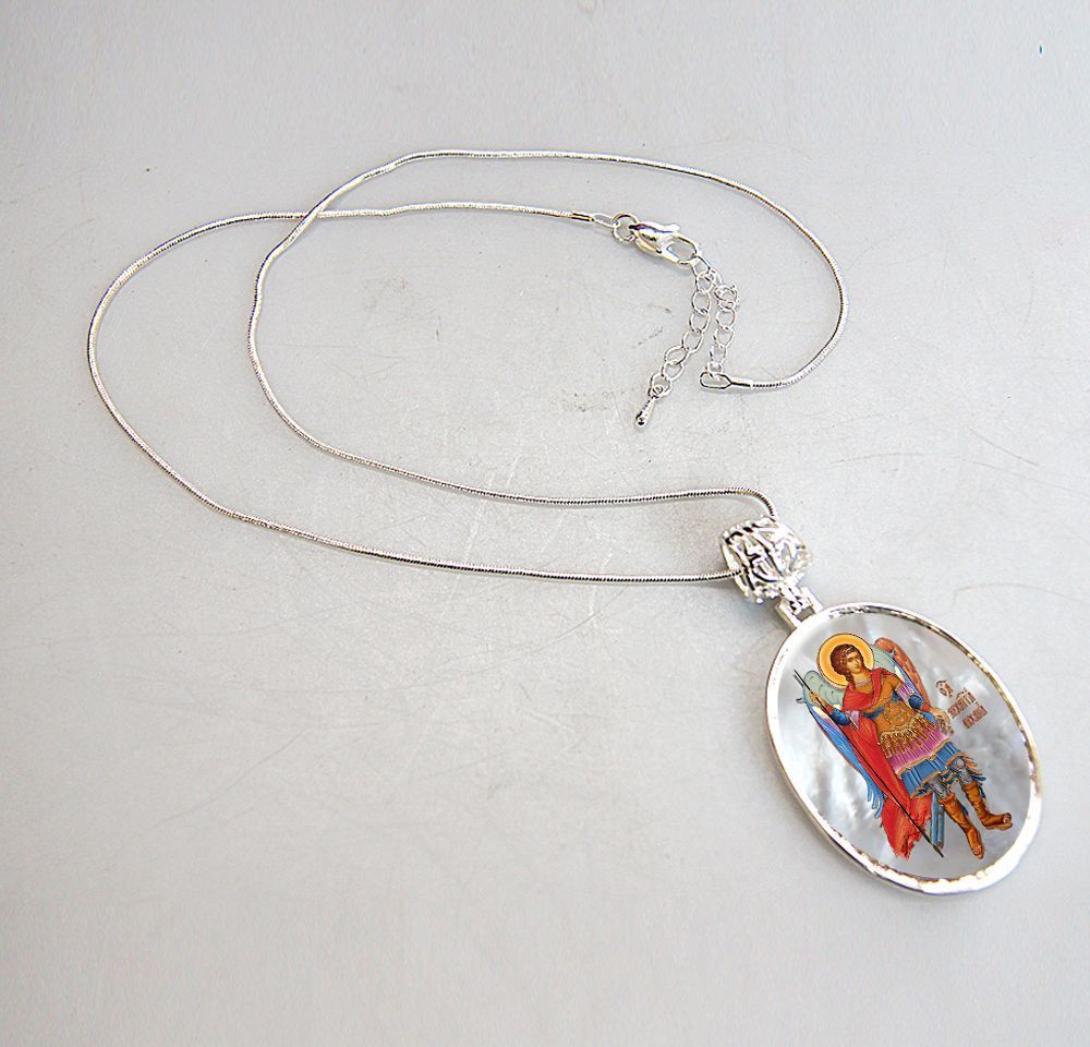A beautifully handcrafted Saint Michael the Archangel necklace, with a hand-painted icon on a Mother-of-Pearl cabochon and a silver-plated chain.