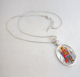A beautifully handcrafted Saint Michael the Archangel necklace, with a hand-painted icon on a Mother-of-Pearl cabochon and a silver-plated chain.
